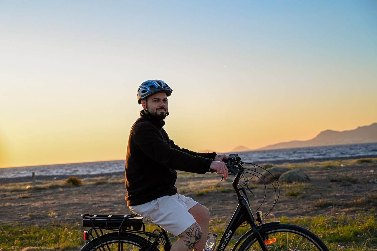 Rider watching the golden hour over the sea