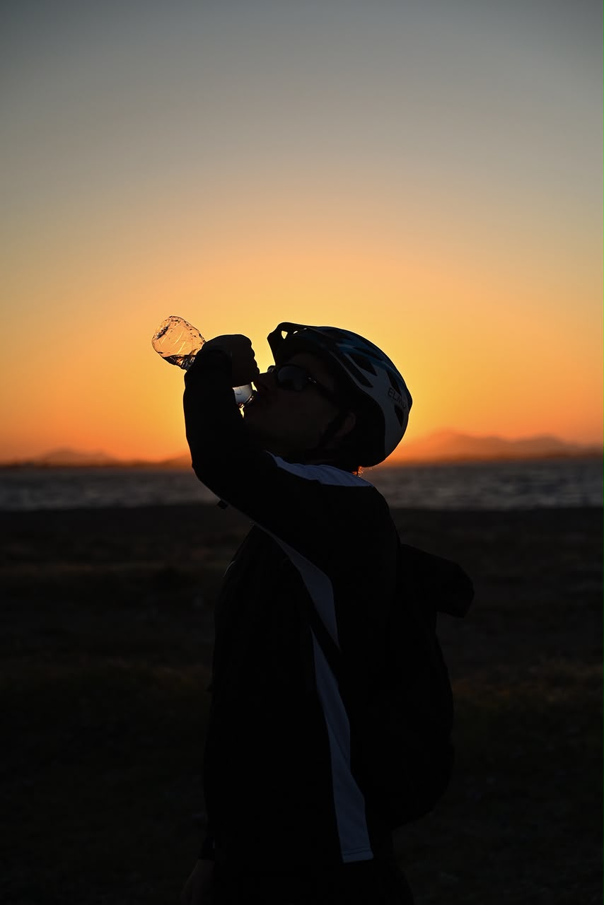 Rider taking a water break at sunset